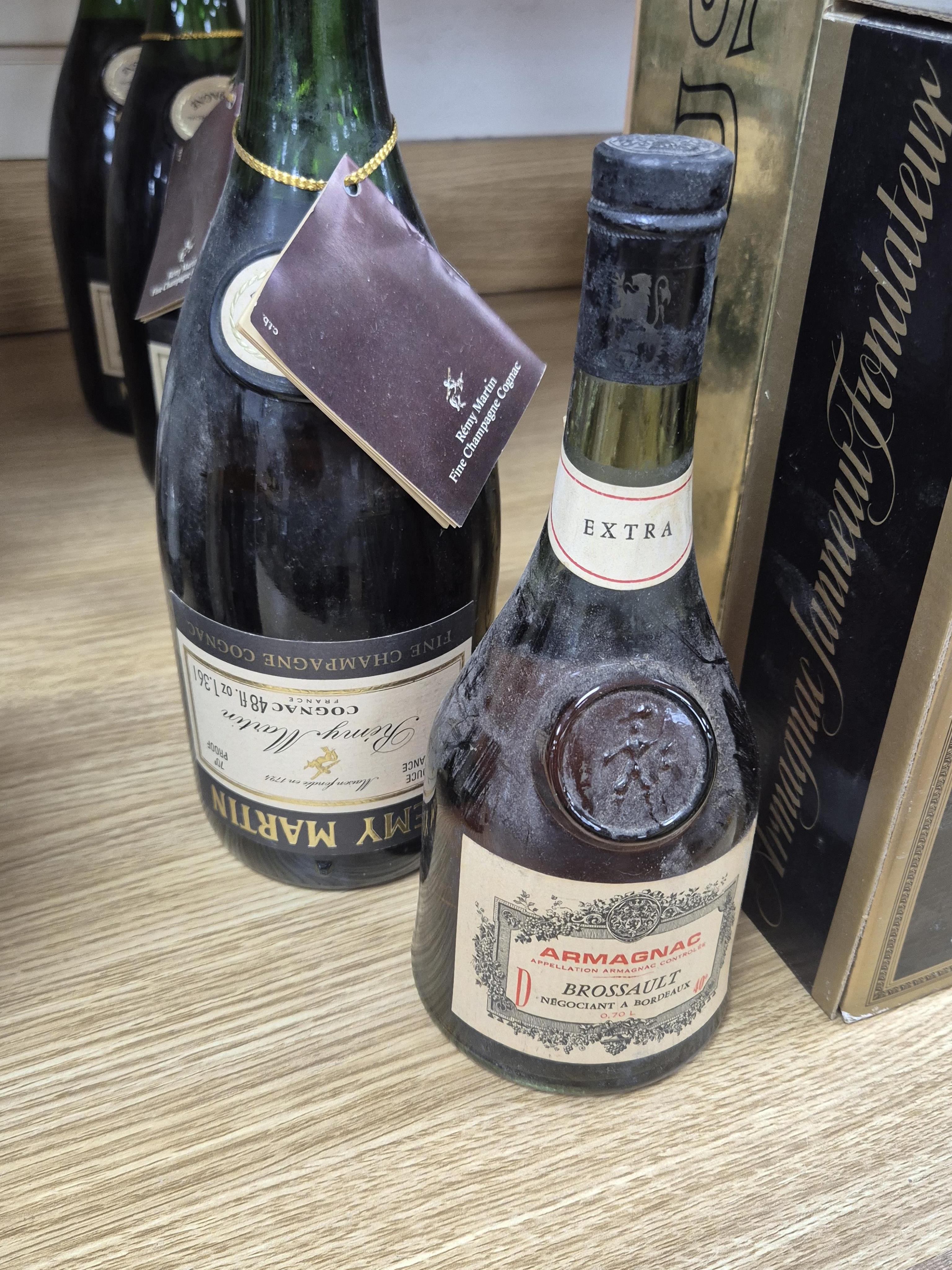 Four bottles of Remy Martin Fine VS Champagne Cognac, 48 fl.oz, 70% proof (for optics, as labels upside down), one bottle of Armagnac Brossault Extra, one boxed bottle of Camus Cognac Celebration and one boxed bottle of